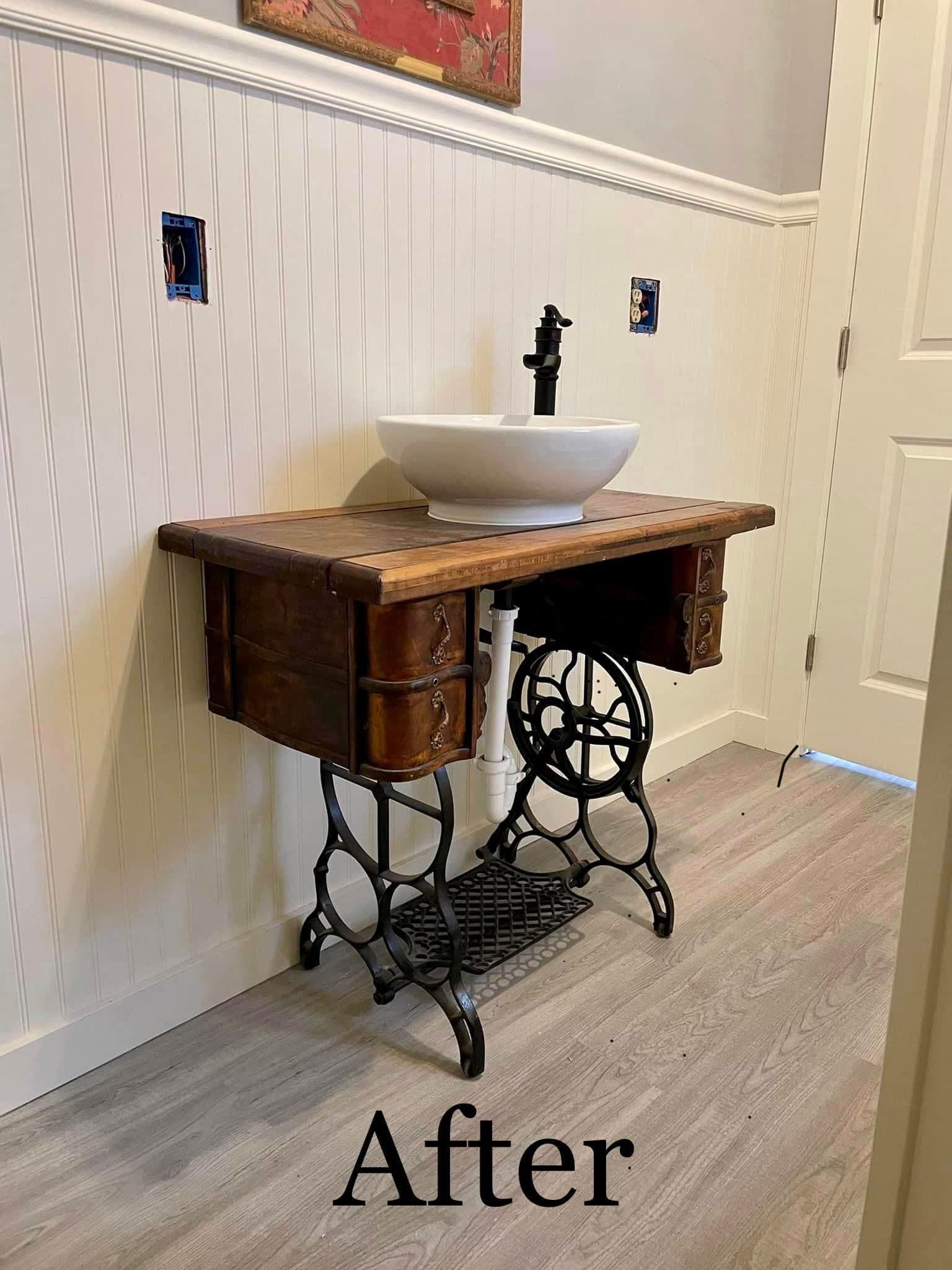 Custom bathroom vanity built from an antique treadle sewing machine base with a white vessel sink